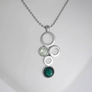 Silver pendant with green glass paste stones